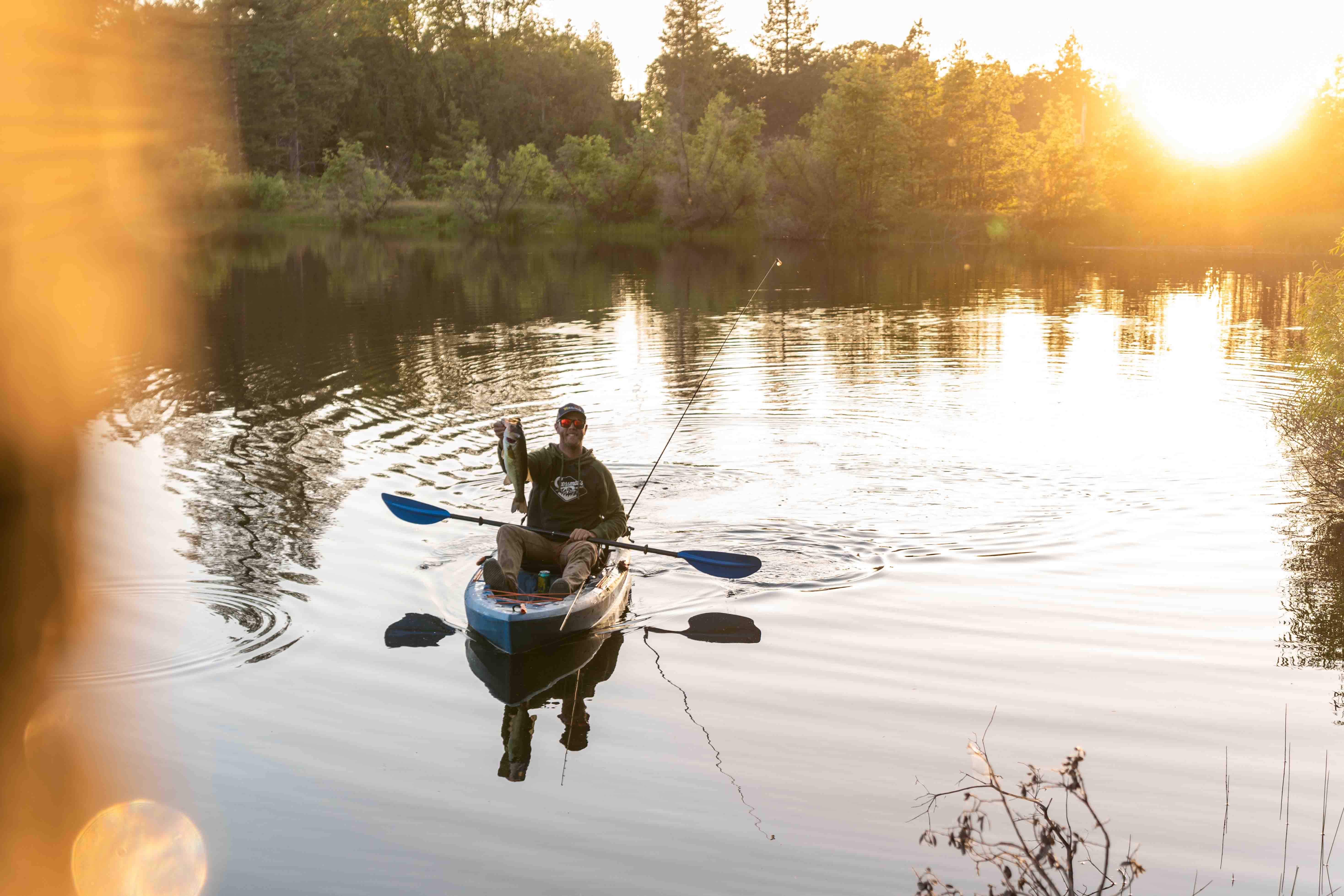 Jeremiah Y. fishing paddle on lake.jpeg